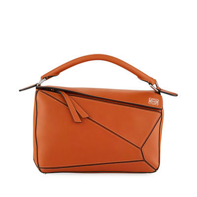 LOEWE 'Puzzle' Shoulder Bag. Original Quality Bag including gift box, care book, dust bag, authenticity card. The first completely new bag designed by Jonathan Anderson has become a LOEWE icon. With its innovative cuboid shape, extreme tactility and maximum utility, the volume is created through a precise cutting so the Puzzle bag can be worn in five different ways, from shoulder bag to clutch and folds completely until it´s flat. Key features: expertly crafted from calfskin, black hand-painted edges, herringbone-patterned cotton-canvas lining, and two internal slip compartments, handy exterior zip back pocket, embossed anagram. Removable adjustable shoulder strap for the most comfortable length. | CRIS&COCO Authentic Quality bags and Accessories