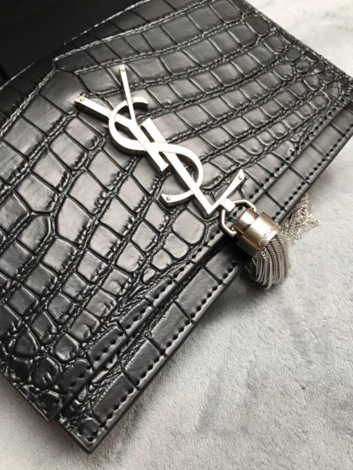 SAINT LAURENT Small 'Kate' Bag with Tassel. Original Quality Bag including gift box, care book, dust bag, authenticity card. Monogram Saint Laurent bag adorned with a curb chain, interlocking YSL initials in metal, and a metallic tassel. Crafted from leather, this Kate shoulder bag from Saint Laurent is decorated with a signature YSL monogram plaque and a hanging tassel detail to the front for an extra refined touch. The perfect go-to for a night out. Featuring a chain shoulder strap, a foldover top with magnetic closure, a main internal compartment, an internal slip pocket, an internal logo patch, an internal logo stamp, and metal hardware. | CRIS&COCO Authentic Quality Designer Bags and Luxury Accessories