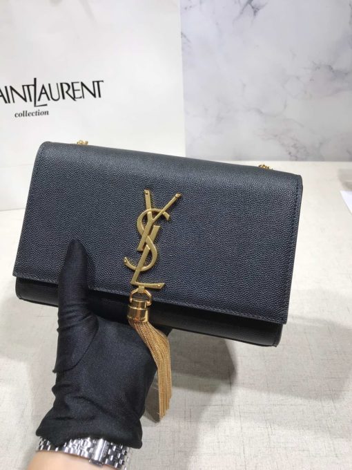 SAINT LAURENT Small 'Kate' Bag with Tassel. Original Quality Bag including gift box, care book, dust bag, authenticity card. Monogram Saint Laurent bag adorned with a curb chain, interlocking YSL initials in metal, and a metallic tassel. Crafted from leather, this Kate shoulder bag from Saint Laurent is decorated with a signature YSL monogram plaque and a hanging tassel detail to the front for an extra refined touch. The perfect go-to for a night out. Featuring a chain shoulder strap, a foldover top with magnetic closure, a main internal compartment, an internal slip pocket, an internal logo patch, an internal logo stamp, and metal hardware. | CRIS&COCO Authentic Quality Designer Bags and Luxury Accessories