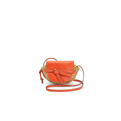 LOEWE Gate Mini Raffia Crossbody Bag. Original Quality Bag. Authentic Soft Calfskin and Woven Raffia. LOEWE Sales Box and Dust Bag. Booklet, Authenticity Card, Payment Slip. Finish off your look with this summery woven raffia iteration of Loewe's beloved Gate bag. The mini silhouette features a contrasting flap closure, which has been made from calf leather with an elegant knot detail wrapping over the front. Think of it as the sort of piece that you'll buy now but love forever. | CRIS&COCO | High quality designer bags and authentic luxury