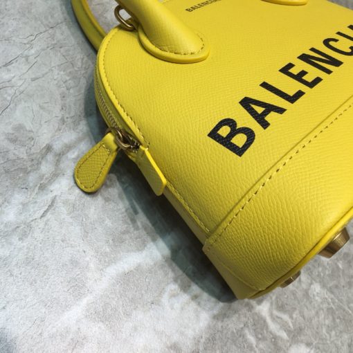 BALENCIAGA Mini Ville Logo Leather Bag. Original Quality Bag. Authentic Epi leather. Metal Toned Hardware. BALENCIAGA Sales Box and Dust Bag. Authenticity Card. BALENCIAGA's Ville mini bowling bag is crafted of grained calfskin printed with a large statement logo at the front and back. This design works as a zipped-top construction with a padlock charm to ensure your valuables are securely stowed. The versatile style can be carried by its rolled handles or over the shoulder via a detachable flat strap. | CRIS&COCO Authentic Quality Designer Bags and Luxury Accessories