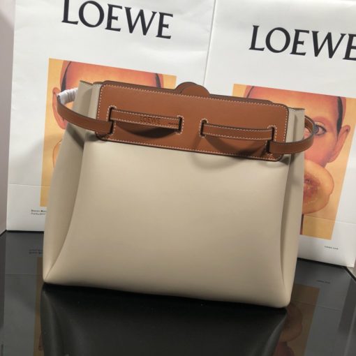 LOEWE Lazo Top Handle Bag. Authentic Quality Bag with literature, gift box, dust bag and authenticity card. A highly chic and sophisticated bag, the Lazo features the recognizable emblematic Gate knot. Contrasting calfskin straps holds the bag, cinching to fasten the bag effortlessly. Creating a sinuous accordion soft silhouette with soft natural calfskin, this novel interpretation is the next must-have chic functional bag of the season. The soft and slouchy calfskin bag is devoid of any zips for the closure and instead relies on the contrasting calfskin straps to cinch and fasten the opening. A relaxed update on a classic bag design. | CRIS&COCO Authentic Quality Designer Bags and Luxury Accessories