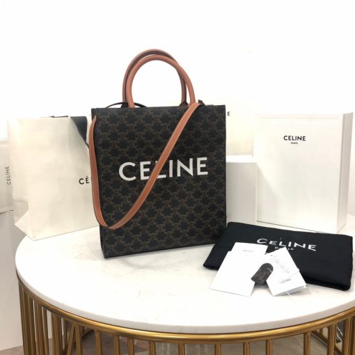 CELINE Vertical Cabas Tote in Triomphe Canvas and Calfskin. Original Quality Bag including gift box, literature, dust bag, authenticity card. The Triomphe bag wasn’t really loved in the beginning, but its gaining traction and fame. The story started with the CELINE Triomphe bag, a magnificent bag that’s named after the Arc the Triomphe. A new chapter has started, CELINE has completed an entire collection of the Triomphe line. It includes a tote bag, bucket bag, camera bag, drawstring bag, and a Boston bag. All of these styles are made from Triomphe canvas and with calfskin trimming. | CRIS AND COCO | Authentic Quality Designer Bags and Luxury Accessories
