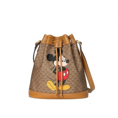 DISNEY x GUCCI Bucket Bag. Authentic Quality Bag including gift box, literature, dust bag, authenticity card. DISNEY and GUCCI come together for an exclusive collection. Mickey Mouse’s playful image defines this GG canvas bucket bag, trimmed with light brown leather details that convey a vintage look and feel. DISNEY’s legendary character appears throughout GUCCI’s ready-to-wear and accessories for the Cruise 2020 collection, displayed as colorful prints, embroidered patches or jacquard motifs.| Cris and Coco. Authentic Quality Designer Bags and Luxury Accessories