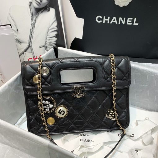 CHANEL Flap Bag with Charms, best high-end quality bag with gift box, dust bag, authenticity card, and CHANEL cloth flower. We love the square-shaped design with a built-in handle for hand carry. Charms give the bag a Punk feel. The center features the CC logo and a woven leather chain strap allows for shoulder carry. | Cris and Coco authentic quality designer bags and luxury accessories.