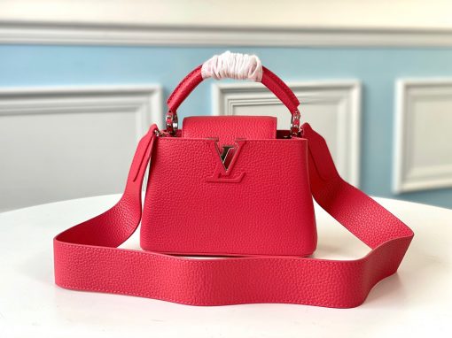 LOUIS VUITTON Capucines Mini. Original Quality Bag including gift box, literature, dust bag, authenticity card. Fashioned from vibrantly colored Taurillon leather, the Capucines Mini handbag pops. The fresh new colorway is perfectly complemented by the discreet metal handle rings. Like all Capucines, the Mini can be carried with the flap out for simple sophistication or tucked inside to feature the LV Initials. | CRIS&COCO Authentic Quality Designer Bag and Luxury Accessories