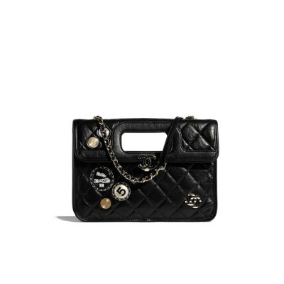 CHANEL Flap Bag with Charms, best high-end quality bag with gift box, dust bag, authenticity card, and CHANEL cloth flower. We love the square-shaped design with a built-in handle for hand carry. Charms give the bag a Punk feel. The center features the CC logo and a woven leather chain strap allows for shoulder carry. | Cris and Coco authentic quality designer bags and luxury accessories.