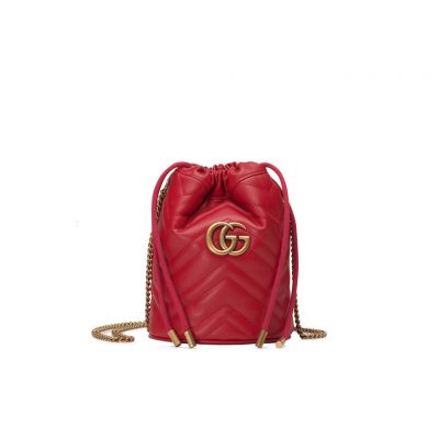 GUCCI GG Marmont Mini Bucket Bag. Original Quality Bag including gift box, literature, dust bag, authenticity card. The world of GG Marmont expands with the introduction of a mini bucket bag shape crafted from Matelassé leather in vibrant tones. Inspired by an archival design from the '70s, a hallmark era of the House, the Double G decorates the front of this accessory. Featuring a chain strap and drawstring closure the versatile shape can be worn as shoulder and as a crossbody bag. | Cris and Coco. High Quality Bags and Luxury Accessories