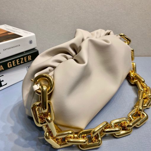 BOTTEGA VENETA The Chain Pouch. Original Quality Bag including gift box, literature, dust bag, authenticity card. BOTTEGA VENETA updates its cult Pouch bag with a chunky golden chain handle – a detail seen throughout the runway show. Crafted from supple Nappa leather in wear-with-anything shades, its magnetic frame is covered in voluminous folds that echo the brand's modern interpretation of its heritage. |CRIS AND COCO Authentic Quality Designer Bags and Luxury Accessories