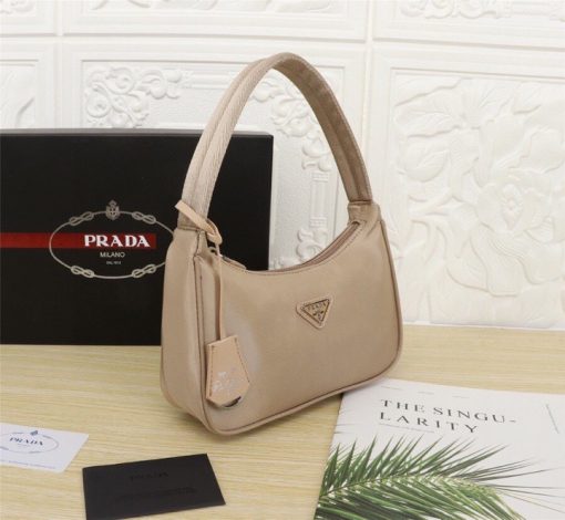 PRADA Re-Edition 2000 Nylon Mini Hobo. High-End Bag including gift box, dust bag, literature, and authenticity card. Practical and feminine, the nylon mini bag is decorated with iconic Saffiano leather trim. It features a contemporary mix of materials. | CRIS and Coco High-End Luxury Accessories