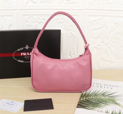 PRADA Re-Edition 2000 Nylon Mini Hobo. High-End Bag including gift box, dust bag, literature, and authenticity card. Practical and feminine, the nylon mini bag is decorated with iconic Saffiano leather trim. It features a contemporary mix of materials. | CRIS and Coco High-End Luxury Accessories
