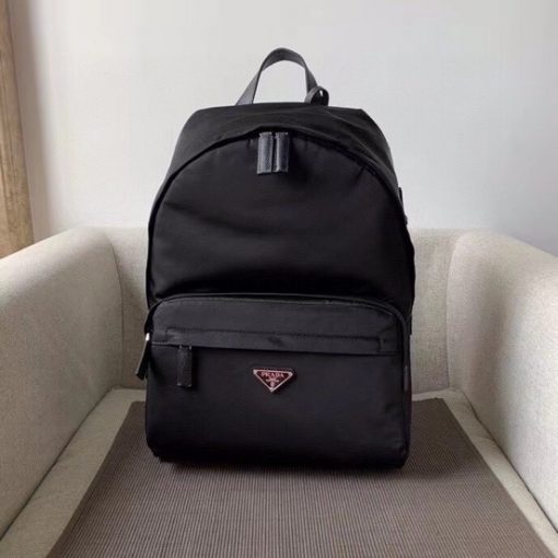 PRADA Black Logo Plaque Nylon and Saffiano Leather Backpack. Original Quality Bag including gift box, literature, dust bag, authenticity card. Practicality is key but style is always appreciated, too. Detailed with the brand's signature enameled triangle logo plaque to the front for an extra refined touch, this backpack from Prada is the perfect go-to for whenever you need to carry everything but the kitchen sink. Best of both worlds. | CRIS&COCO Authentic Quality Bags And Luxury Accessories