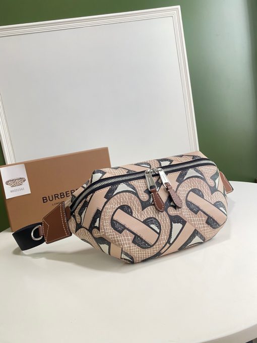 BURBERRY Monogram Print E-Canvas Sonny Bum Bag. Original Quality Bag including gift box, care book, dust bag, authenticity card. A 1990s streetwear staple reimagined in e-canvas – an environmentally conscious canvas, primarily made using renewable resources that require less water and generate less CO2 than conventional coated canvases. The design is animated with a graphic Monogram print. Carry it crossbody, by the strap or around the waist. | CRIS&COCO Authentic Quality Designer Bags and Luxury Accessories