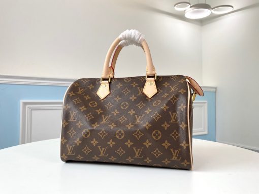 LOUIS VUITTON Speedy 30. Original Quality Bag including gift box, care book, dust bag, authenticity card. Made from iconic Monogram canvas, the LV Speedy 30 is an elegant, compact handbag, a stylish companion for city life. Launched in 1930 as the "Express" and inspired by that era's rapid transit, today’s updated Speedy remains a timeless House icon, with its unmistakable silhouette, rolled leather handles, and engraved, signature padlock. | CRIS&COCO Authentic Quality Bags and Luxury Accessories