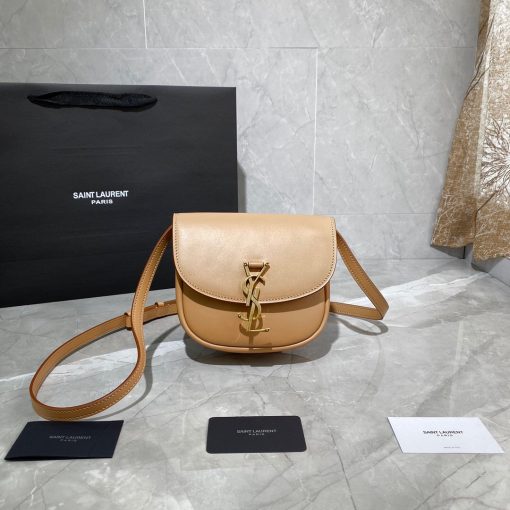 SAINT LAURENT Kaia YSL-Plaque Leather Cross-Body Bag. Original Quality Bag including gift box, care book, dust bag, authenticity card. SAINT LAURENT'S Kaia bag features the label's signature YSL plaque which was sketched by the graphic designer A.M. Cassandre, one of the 20th century's most prominent poster artists. It's crafted from leather to a curved silhouette that's reminiscent of a saddle, then accented by white topstitching. Carry it by the adjustable shoulder strap for contemporary polish. | CRIS and COCO Authentic Quality Designer Bags and Accessories