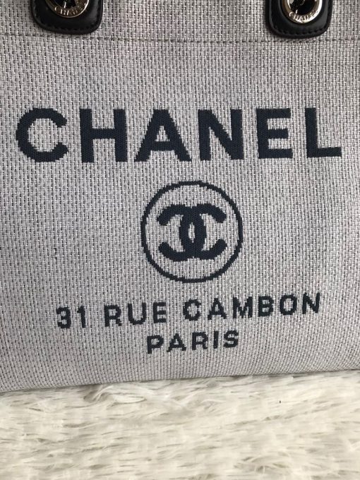 CHANEL Large Deauville Shopping Bag 2021. Authentic quality bag including gift box, booklet, dust bag, authenticity card. The CHANEL Deauville tote matured to a signature CHANEL bag. The bestseller Deauville often appears in seasonal launches in unexpected colors and materials. On the CHANEL website, Chanel calls it the Shopping Bag, but if you walk into a CHANEL boutique and ask for the Deauville, you will be directed to this tote bag. | Cris and Coco Authentic Quality Designer Bags and Luxury Accessories