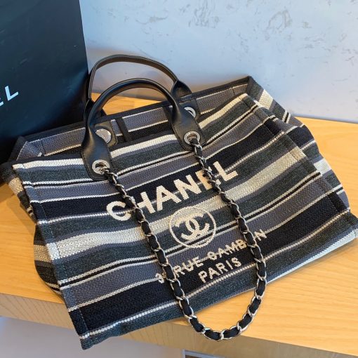 CHANEL Large Deauville Shopping Bag 2021. Authentic quality bag including gift box, booklet, dust bag, authenticity card. The CHANEL Deauville tote matured to a signature CHANEL bag. The bestseller Deauville often appears in seasonal launches in unexpected colors and materials. On the CHANEL website, Chanel calls it the Shopping Bag, but if you walk into a CHANEL boutique and ask for the Deauville, you will be directed to this tote bag. | Cris and Coco Authentic Quality Designer Bags and Luxury Accessories