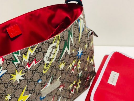 GUCCI GG Supreme Baby Changing Bag. Original Quality Bag including gift box, care book, dust bag, authenticity card. A baby changing bag crafted from Supreme canvas is animated by a print that recalls outer space–a theme used throughout Gucci's collections. Set against the House's emblematic monogram motif, the baby changing diaper bag is defined by spaceships, stars, and images from the galaxy. Also, outer space continues to influence Gucci's latest collections in new, whimsical ways. | CRIS&COCO Authentic Quality Designer Bags and Luxury Accessories