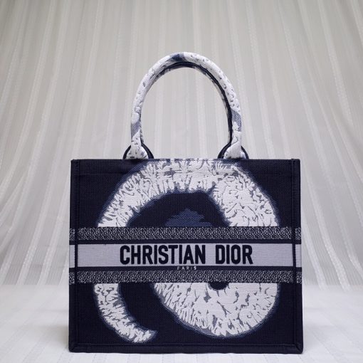 DIOR Book Tote. Original Quality Bag including gift box, care book, dust bag, authenticity card. This Book Tote is an original style introduced by Creative Director Maria Grazia Chiuri. This has become a staple of the Dior aesthetic. Ideally designed to carry all your daily essentials, the small shape is fully embroidered and the 'Christian Dior' signature on the front. This carryall is a perfect example of the Dior savoir-faire and also may be coordinated with a pouch or other small leather goods for a complete look. | CRIS&COCO Authentic Quality Designer Bags and Luxury Accessories