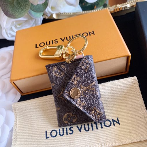 LOUIS VUITTON Kirigami Pouch Bag Charm & Key Holder. Original Quality Charm including gift box, care book, dust bag, authenticity card. Practicality and elegance fuse effortlessly in this pouch bag charm and key holder. The versatile design, finished in iconic Monogram canvas, features a functional pouch with a snap button opening. Immaculate detailing includes a suede lining and House emblems such as an LV Circle charm and signature engraving. | CRIS&COCO Authentic Quality Designer Bags and Luxury Accessories