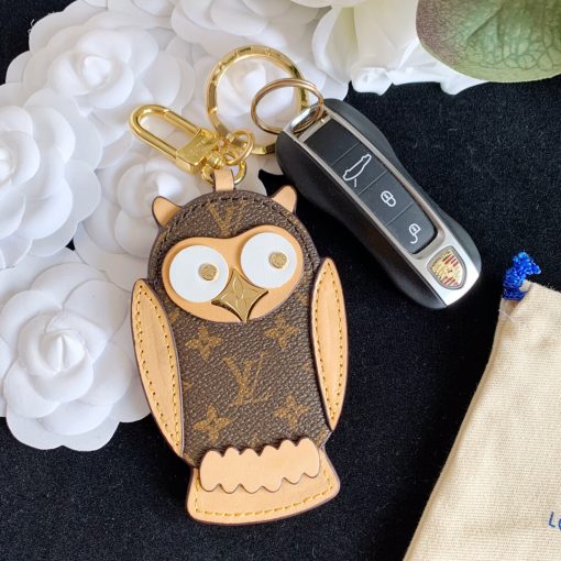 LOUIS VUITTON Owl Bag-Charm & Key Holder. Original Quality Charm including gift box, care book, dust bag, authenticity card. The mascot on the Owl bag charm and key holder is brought to life with LV studs for eyes and a Monogram Flower beak. Gold-color hardware joins calf leather and Monogram Eclipse canvas in a playful mingling of the House's signature materials. The hook and ring on this are both engraved with the Louis Vuitton signature for an elegant finish. | CRIS&COCO Authentic Quality Designer Bags and Luxury Accessories