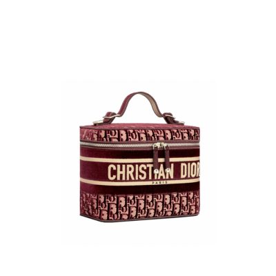 DIOR 'DiorTravel' Vanity Case. Original Quality Bag including gift box, care book, dust bag, authenticity card. The burgundy dior oblique embroidered velvet vanity case is crafted in the House's signature Cannage motif. The elegant design is fully embroidered, while the 'Christian Dior' signature accents the exterior. Pockets at the interior allow for a range of storage options, and a zip closure completes the piece. | CRIS&COCO Authentic Quality Designer Bags and Luxury Accessories