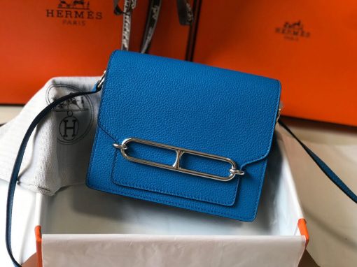 HERMÈS Mini Roulis 18 Bag. Original Quality Bag including gift box, care book, dust bag, authenticity card. The HERMÈS Roulis Bag is stunning, modest, and elegant creativity from Hermes. A nostalchic and retrofuturistic drifter, the Roulis trades its good behavior and stately demeanor for mischievous strolls and boat trips. Its jewel clasp revisits the “Chaîne d’ancre” link. This laid-back, practical, chic piece, in its mini-size version, crosses oceans and decades at full speed. | CRIS&COCO Authentic Quality Designer Bags and Luxury Accessories