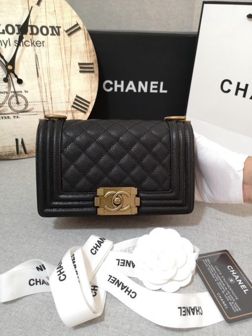 CHANEL Small Boy Handbag. Original Quality Bag including gift box, care book, dust bag, authenticity card. Even though the Boy was only introduced in 2011, the style has quickly achieved the status of an icon. Designed by Karl Lagerfeld and named after Boy Capel, the now legendary love of Coco Chanel’s life, the bag encapsulates masculine chic conveyed through rigid structure, boxy shape and sharp corners. This CHANEL Small Handbag is instantly recognizable for its simple, boxy silhouette and sharp corners, embellished only with a contrasting, bold-looking link chain strap which is the main feature of the bag. This most popular variations of the Chanel Boy are available in either caviar or lambskin. There are no external pockets and the sole adornment is the quilted fascia. | CRIS&COCO Authentic Quality Designer Bags and Luxury Accessories