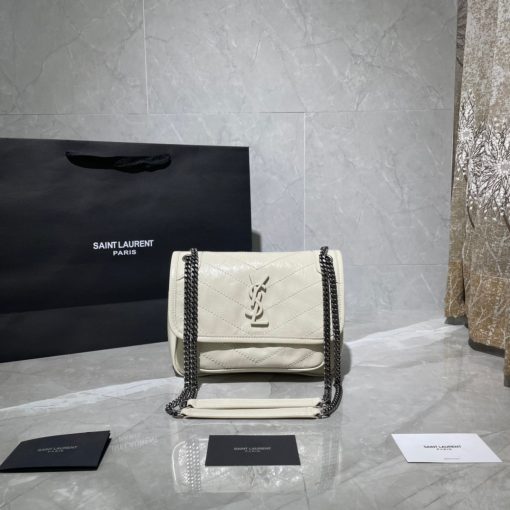 SAINT LAURENT Niki Baby in Crinkled Vintage Leather. Original Quality Bag including gift box, care book, dust bag, authenticity card. This bag is much more than a shoulder bag. It’s practical, elegant and modern. The chain really adds a nice finishing touch to it. The center comes with the signature YSL logo, which makes the bag very classy. The crinkled leather is eye-catching and creates a nice texture for the luxury experience. SAINT LAURENT monogram bag featuring a relaxed shape, a rectangular body, a quilted effect, a fold over top with magnetic closure, a front logo plaque, a main internal compartment, an internal zipped pocket, a front slip pocket and a leather convertible shoulder strap. | CRIS&COCO Authentic Quality Designer Bags and Luxury Accessories