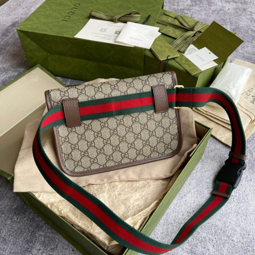 GUCCI Neo Vintage GG Supreme belt bag. The belt bag in GG Supreme has a retro-influenced design. Trimmed with leather, the style is meant to be worn around the waist, securing with a Web strap and buckle closure. Beige/ebony GG Supreme canvas, a material with low environmental impact, with brown leather trims. Green and red Web. Oval Gucci leather tag with a feline head. Adjustable nylon Web belt with plastic buckle closure. | CRIS&COCO Authentic Quality Designer Bags and Luxury Accessories