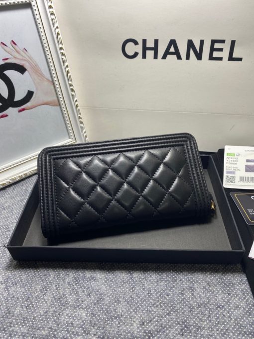 CHANEL 'Boy' Long Zipped Wallet. Original Quality Wallet with literature, dust bag, box and authenticity card. The Chanel 'Boy' Wallets have always been as popular as the Boy Chanel Quilted Bags. Everything about the design resemble to the Boy Bag line including the quilting with stripes on the edges and the boy clasp as well. The calfskin/lambskin makes sure that you don’t need to constantly babying it and it will not get damaged so easily if it sits next to your keys, inside your bag. This wallet is practical and amazing; perfect to hold paper money, credit cards and coins.| CRIS&COCO Authentic Quality Designer Bags and Luxury Accessories