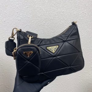 PRADA Padded Shoulder Bag. Authentic quality luxury bag crafted in genuine leather comes with authenticity card, dust bag and gift bag. Patchwork elegance meets functional versatility in this chic leather shoulder bag. This padded leather shoulder bag has a unique triangle-shaped patchwork stitching design, giving it a distinctive look. It features an adjustable logo-print woven nylon shoulder strap for added comfort. The front of the bag is adorned with the iconic enameled metal triangle logo, adding a touch of elegance. Additionally, this versatile accessory comes with a detachable zipper pouch that can be conveniently attached to the shoulder strap.