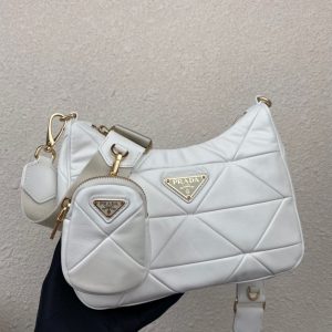 PRADA Padded Shoulder Bag. Authentic quality luxury bag crafted in genuine leather comes with authenticity card, dust bag and gift bag. Patchwork elegance meets functional versatility in this chic leather shoulder bag. This padded leather shoulder bag has a unique triangle-shaped patchwork stitching design, giving it a distinctive look. It features an adjustable logo-print woven nylon shoulder strap for added comfort. The front of the bag is adorned with the iconic enameled metal triangle logo, adding a touch of elegance. Additionally, this versatile accessory comes with a detachable zipper pouch that can be conveniently attached to the shoulder strap.