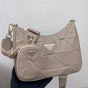 PRADA Padded Shoulder Bag. Authentic quality luxury bag crafted in genuine leather comes with authenticity card, dust bag and gift bag. Patchwork elegance meets functional versatility in this chic leather shoulder bag. This padded leather shoulder bag has a unique triangle-shaped patchwork stitching design, giving it a distinctive look. It features an adjustable logo-print woven nylon shoulder strap for added comfort. The front of the bag is adorned with the iconic enameled metal triangle logo, adding a touch of elegance. Additionally, this versatile accessory comes with a detachable zipper pouch that can be conveniently attached to the shoulder strap.