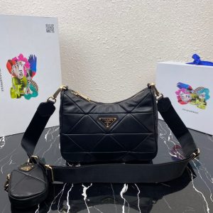 PRADA Padded Shoulder Bag. Authentic quality luxury bag crafted in genuine leather comes with authenticity card, dust bag and gift bag. Patchwork elegance meets functional versatility in this chic leather shoulder bag. This padded leather shoulder bag has a unique triangle-shaped patchwork stitching design, giving it a distinctive look. It features an adjustable logo-print woven nylon shoulder strap for added comfort. The front of the bag is adorned with the iconic enameled metal triangle logo, adding a touch of elegance. Additionally, this versatile accessory comes with a detachable zipper pouch that can be conveniently attached to the shoulder strap.