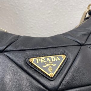 PRADA Padded Shoulder Bag. Authentic quality luxury bag crafted in genuine leather comes with authenticity card, dust bag and gift bag. Patchwork elegance meets functional versatility in this chic leather shoulder bag. This padded leather shoulder bag has a unique triangle-shaped patchwork stitching design, giving it a distinctive look. It features an adjustable logo-print woven nylon shoulder strap for added comfort. The front of the bag is adorned with the iconic enameled metal triangle logo, adding a touch of elegance. Additionally, this versatile accessory comes with a detachable zipper pouch that can be conveniently attached to the shoulder strap.