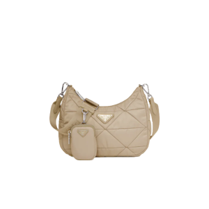 PRADA Padded Shoulder Bag. Authentic quality luxury bag crafted in genuine leather comes with authenticity card, dust bag and gift bag. Patchwork elegance meets functional versatility in this chic leather shoulder bag. This padded leather shoulder bag has a unique triangle-shaped patchwork stitching design, giving it a distinctive look. It features an adjustable logo-print woven nylon shoulder strap for added comfort. The front of the bag is adorned with the iconic enameled metal triangle logo, adding a touch of elegance. Additionally, this versatile accessory comes with a detachable zipper pouch that can be conveniently attached to the shoulder strap.