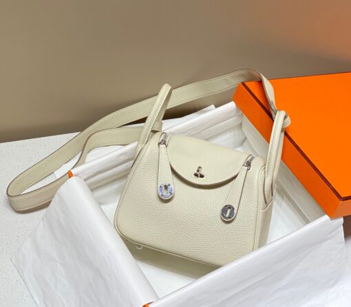 HERMÈS Mini Lindy. High-end quality bag including gift box, literature, dust bag, authenticity card. Maison HERMÈS is elevating the Lindy, with the introduction of the new Mini and is joining the holy Trinity, the Birkin, Kelly, and Constance.| CRIS AND COCO Authentic Quality Luxury Accessories