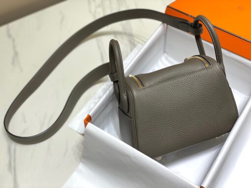 HERMÈS Mini Lindy. High-end quality bag including gift box, literature, dust bag, authenticity card. Maison HERMÈS is elevating the Lindy, with the introduction of the new Mini and is joining the holy Trinity, the Birkin, Kelly, and Constance.| CRIS AND COCO Authentic Quality Luxury Accessories