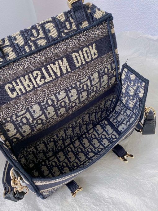 DIOR Small DiorCamp Bag. Original Quality Bag including gift box, care book, dust bag, authenticity card. Maria Grazia Chiuri has updated the classic messenger bag by adding signature Dior details for a relaxed and modern look. Fully embroidered with the Dior Oblique motif, the bag is enhanced by a 'CHRISTIAN DIOR PARIS' signature flap, as well as sportswear-inspired 'CD' buckles. Equipped with an adjustable and removable shoulder strap, the small, compact messenger bag can be worn over the shoulder or crossbody, and will make an ideal urban companion. | CRIS&COCO Authentic Quality Designer Bag and Luxury Accessories
