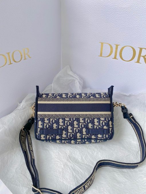 DIOR Small DiorCamp Bag. Original Quality Bag including gift box, care book, dust bag, authenticity card. Maria Grazia Chiuri has updated the classic messenger bag by adding signature Dior details for a relaxed and modern look. Fully embroidered with the Dior Oblique motif, the bag is enhanced by a 'CHRISTIAN DIOR PARIS' signature flap, as well as sportswear-inspired 'CD' buckles. Equipped with an adjustable and removable shoulder strap, the small, compact messenger bag can be worn over the shoulder or crossbody, and will make an ideal urban companion. | CRIS&COCO Authentic Quality Designer Bag and Luxury Accessories