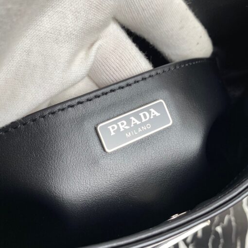 PRADA Cleo Shoulder Bag. Original Quality Bag including gift box, care book, dust bag, authenticity card. The Prada Cleo bag with sophisticated allure reinterprets an iconic design of the brand from the 1990's. Sleek curved lines emphasized by the particular construction rounded on the bottom and sides give this hobo bag a soft, light look. Brushed leather, a modern and versatile material that is distinctive in Prada collections, is ideal for creating always new combinations and contrasts. The enamel triangle logo decorates the silhouette. | CRIS&COCO Authentic Quality Designer Bag and Luxury Accessories
