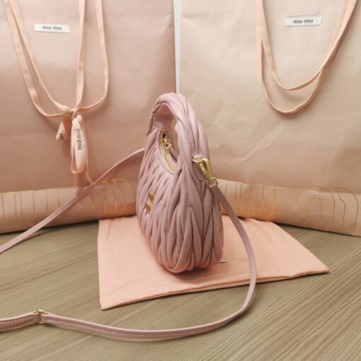 MIU MIU Wander Matelassé Mini Hobo Bag. Original Quality Bag including gift box, care book, dust bag, authenticity card. The Miu Wander bag is reinterpreted season after season, becoming an iconic accessory of Miu Miu collections. Made of matelassé nappa leather, the bag is characterized by the sophisticated, three-dimensional effect created by the refined workmanship. The hobo shape, blending retro inspirations and contemporary elegance, becomes a new synonym of modern femininity. | CRIS&COCO Authentic Quality Designer Bag and Luxury Accessories