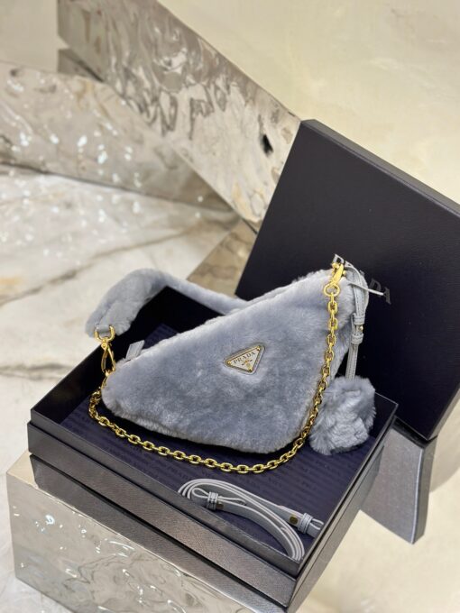 PRADA Shearling Mini Bag. Original Quality Bag including gift box, care book, dust bag, authenticity card. The softness and fuzziness of shearling accentuate the modern, wintry allure of this mini-bag characterized by its harmonious and delicate shape. The bag accented with a chain handle is decorated with the enameled metal triangle logo. | CRIS&COCO Authentic Quality Designer Bags and Luxury Accessories