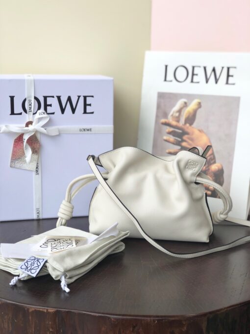 LOEWE Mini Flamenco Clutch. Original Quality Bag including gift box, care book, dust bag, authenticity card. Launched in the 1970s, the Flamenco Clutch cinches closed using drawstring pulls finished in signature coiled knots. This mini version is crafted in nappa calfskin. The Flamenco mini can hold for example a small vertical wallet, most mobile phones (up to 6.1 inches) and sunglasses case. Suitable for shoulder, crossbody or hand carry. | CRIS&COCO Authentic Quality Designer Bags and Luxury Accessories