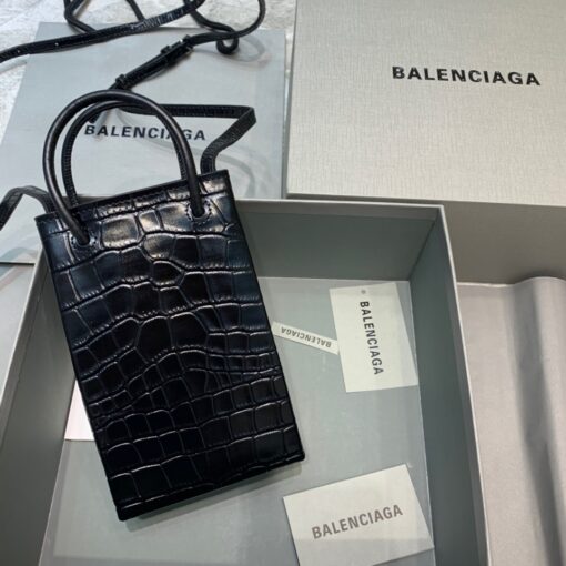 BALENCIAGA Mini Shopping Bag. Original Quality Bag including gift box, care book, dust bag, authenticity card. A new season may be here, but the frenzy for logomania is far from over. At the helm of the trend, Balenciaga continues to offer branded styles. Case in point: this mini shopping bag. Featuring round top handles, a shoulder strap, a strap closure, a main internal compartment and a printed logo to the front. | CRIS&COCO Authentic Quality Designer Bags and Luxury Accessories