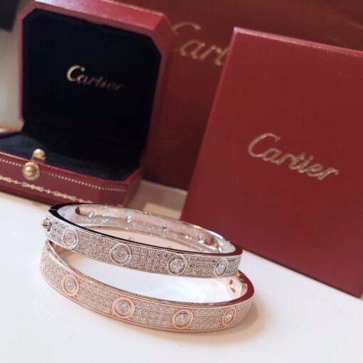 CARTIER Paved Love Bracelet. Original Quality Bracelet including gift box, care book, dust bag, authenticity card. A child of 1970s New York, the LOVE collection remains today an iconic symbol of love that transgresses convention. The screw motifs, ideal oval shape and undeniable elegance establish the piece as a timeless tribute to passionate romance. Studded with zirconia stones, yellow gold, white gold or rose gold: how far would you go for love! Cartier continues to write the story of the Love bracelet. Same design, same oval shape, same story: a timeless – creation which is fastened using a screwdriver. The closure is designed with a functional screw on one side of the bracelet and a hinge on the other. To determine the size of your Love bracelet, measure your wrist, adding one centimeter to your size for a tighter fit, or two centimeters for a looser fit. | CRIS&COCO Authentic Quality Designer Bags and Luxury Accessories