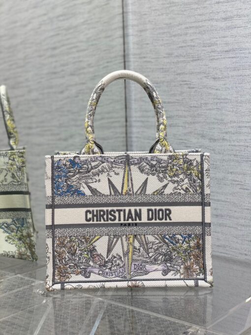 DIOR Small Book Tote. Original Quality Bag including gift box, care book, dust bag, authenticity card. This DIOR Tote is an original creation introduced by Dior's Creative Director, Maria Grazia Chiuri, and has become a staple of the Dior aesthetic. Designed to hold all the daily essentials, it is fully embroidered. Adorned with a Christian Dior Paris signature on the front, the small tote exemplifies the House's signature savoir-faire and may be carried by hand. | CRIS&COCO Authentic Quality Designer Bags and Luxury Accessories