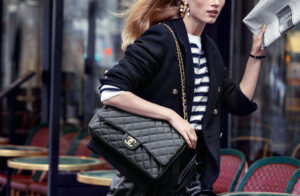 A woman carrying a classic CHANEL Flap Bag, showcasing its iconic quilted leather and interlocking CC logo.