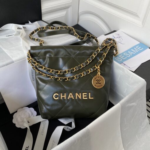 CHANEL 22 Mini Handbag. Original Quality Bag including gift box, care book, dust bag, authenticity card. The Chanel 22 Handbag, has a shape, versatility, and buzz all its own, bringing a casual, even bohemian flare to the always-dressed fashion house. This is crafted of diamond-stitched calfskin leather. The bag features leather threaded silver chain shoulder straps and a matching Chanel logo on the front. The open top with magnetic closure leads to a black fabric interior with a zipper pocket and a removable pouch. | CRIS AND COCO Authentic Quality Luxury Accessories